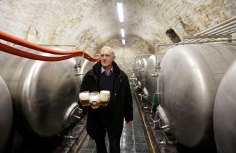 In this photo taken Wednesday, March 18, 2015, Director of Cvikov Brewery Viktor Tkadlec pours glasses of beer in its cellar in Cvikov, Czech Republic. (AP Photo/Petr David Josek).